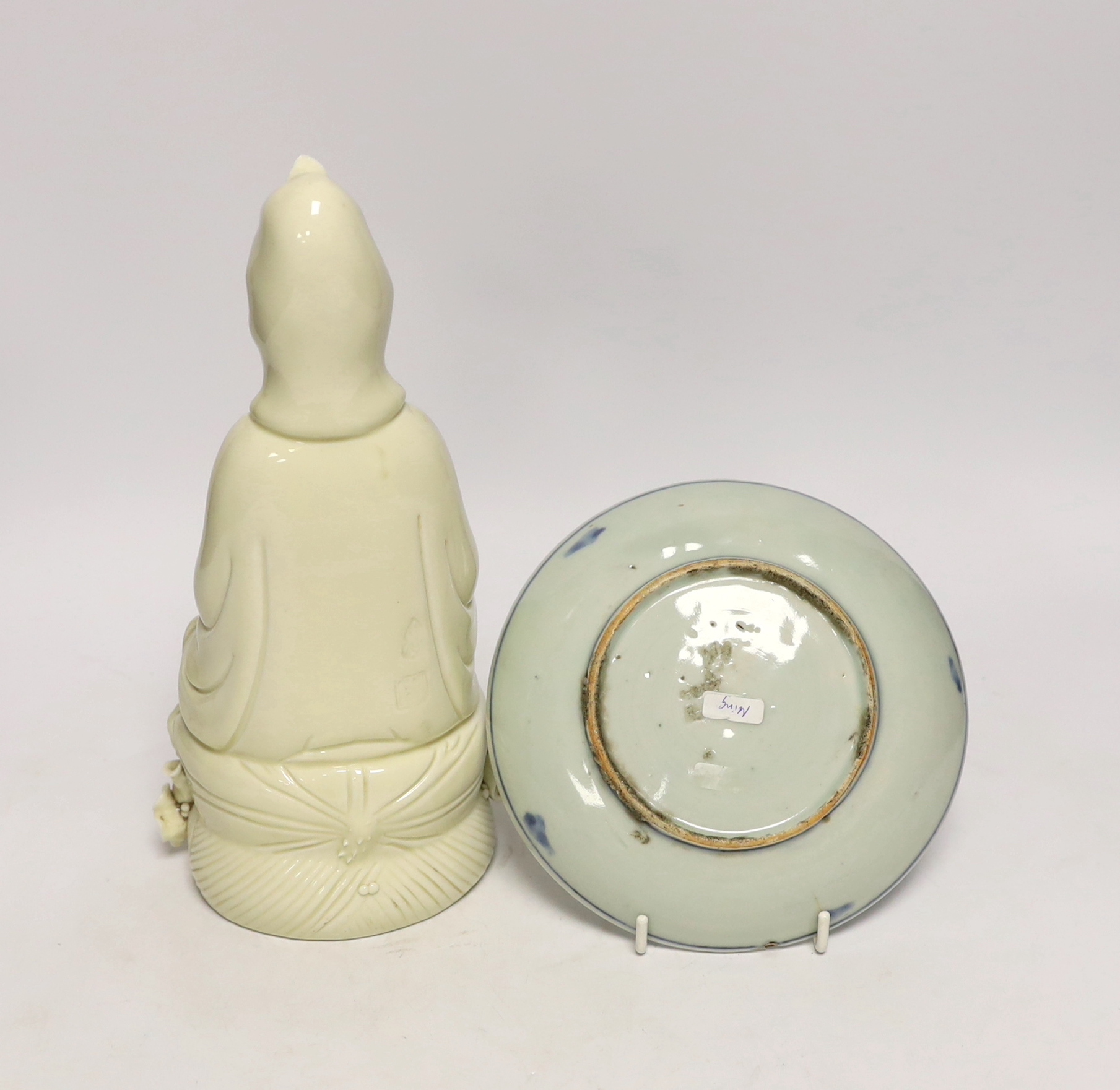 A Chinese Ming blue and white dish and a figure of Guanyin, largest 26cm high